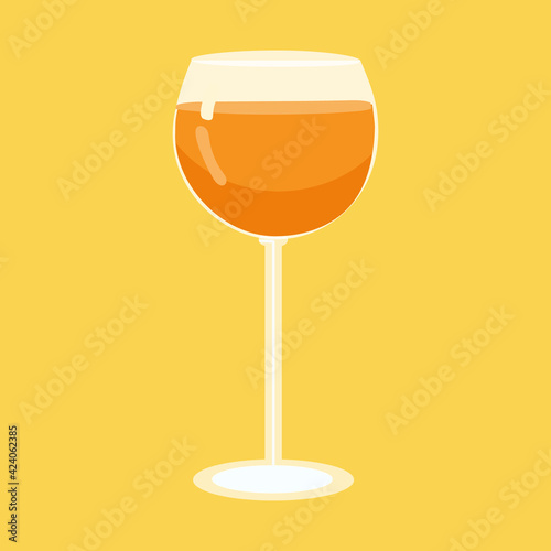 A glass with an orange drink on a yellow background