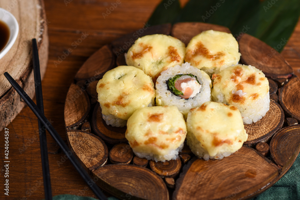 baked rolls with mozzarella and parmesan cheese cap on a wooden board decorated with bamboo leaves baked rolls with mozzarella and parmesan cheese cap on a wooden board decorated with bamboo leaves