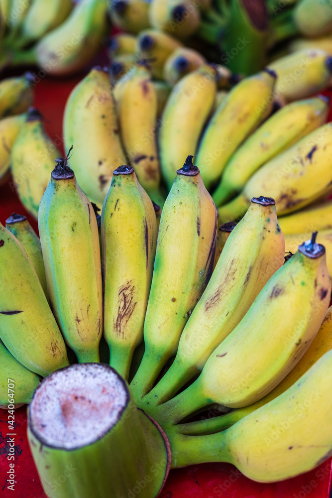 Bunch of ripe Bananas in a street market in Bangkok, Thailand. Vertical