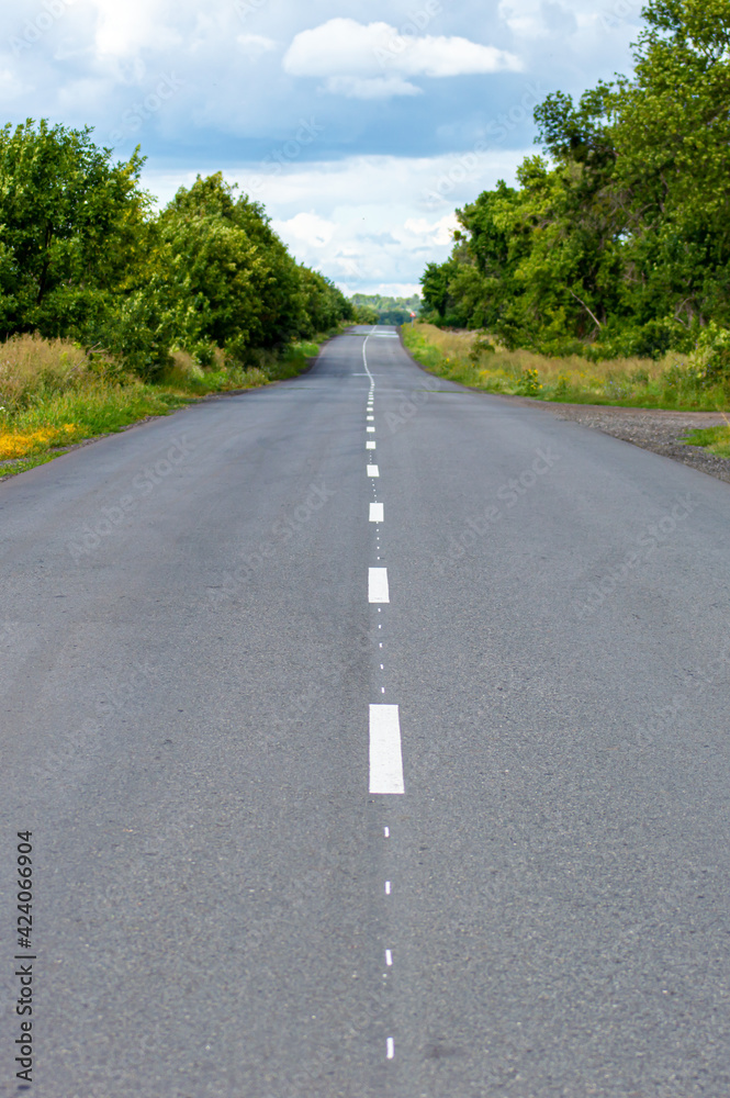 Fototapeta premium Road in the countryside on sunset