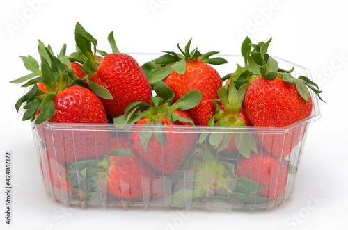 appetizing strawberries in a box close-up on a white background isolated