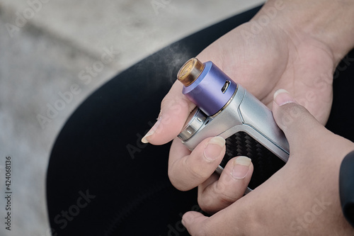 Woman's hands holding electronic cigarette, quit smoking cigarette and tobacco