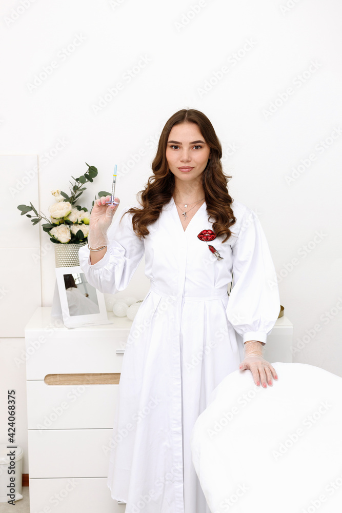 female beautician near couch with syringe in office female beautician near couch with syringe in office