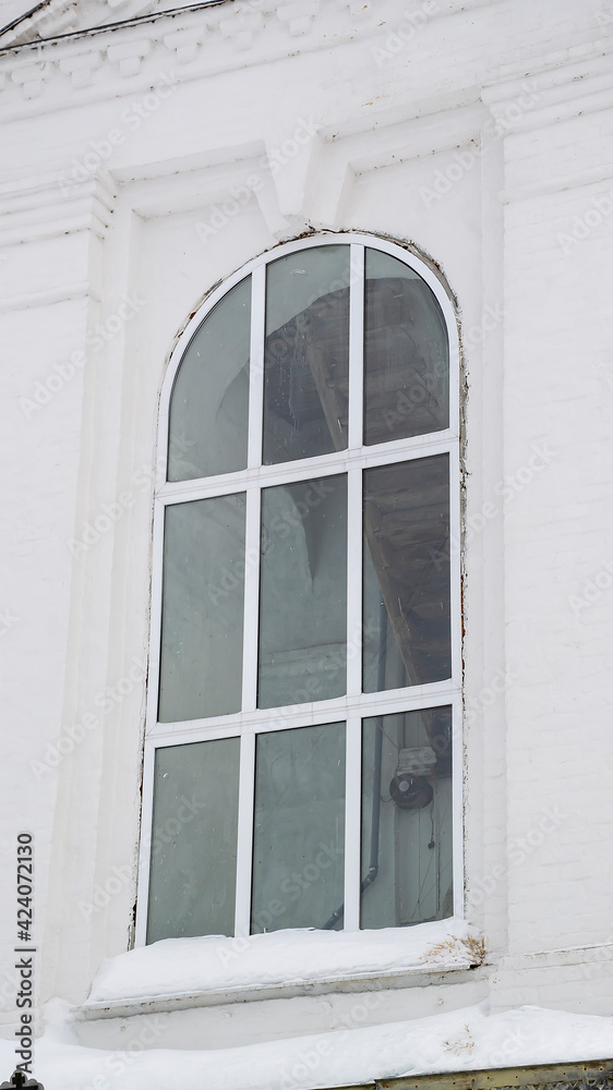 window in a white brick wall