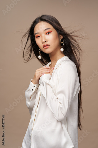 woman asian appearance bright makeup luxury decoration beige background