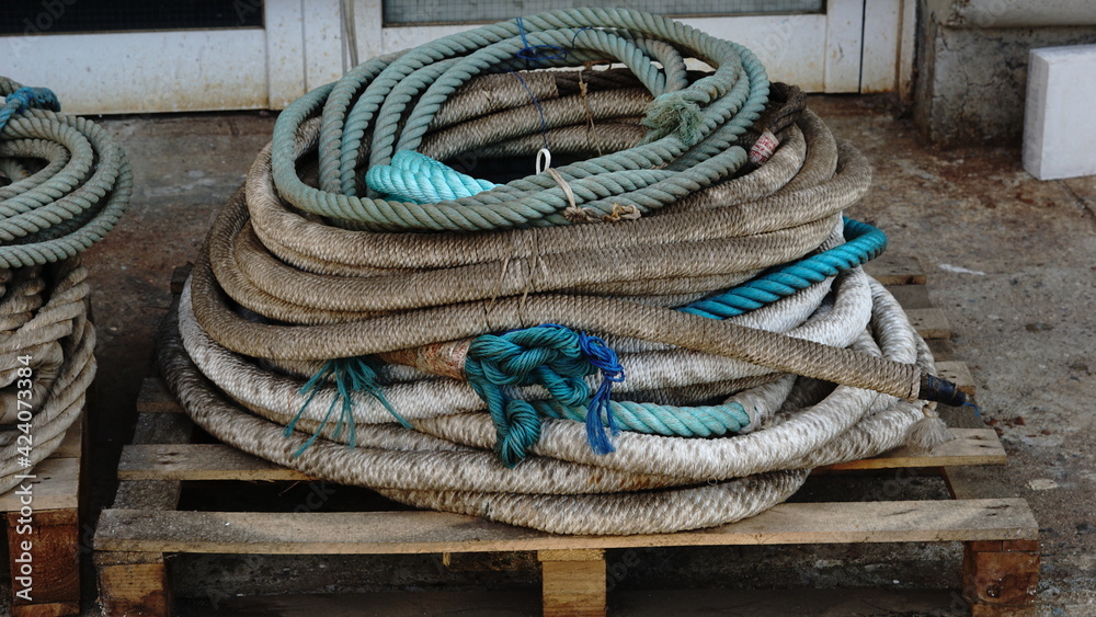 dirty ropes stacked in the harbor