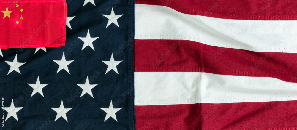Waving US flag with small Chinese flag in upper left corner for Trade War Concept Waving US flag with small Chinese flag in upper left corner for Trade War Concept