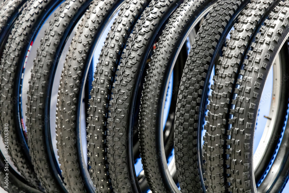 Lots of bike tires. Group of bicycle tires in the store. Different