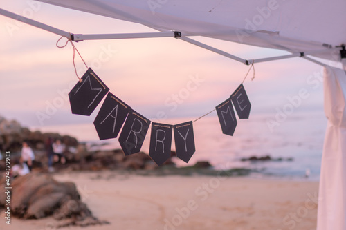 Marry Me sign on the beach