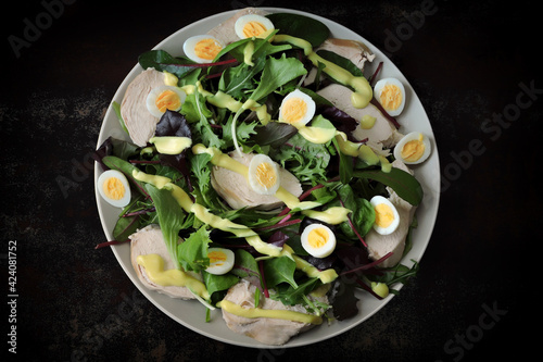 Nutritious salad with chicken breast and quail eggs. Keto diet salad.