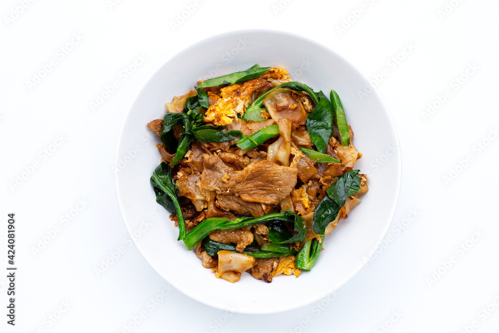 Stir fried flat noodle and pork with soy sauce.