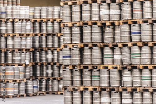 Beer barrels. Beer factory. Beer warehouse. Racks of beer barrels on pallets.