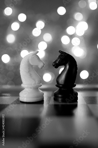chess pieces, horse, white and black on a chessboard, concept of leadership and teamwork in business, duel, opposition of light and dark forces, sports game