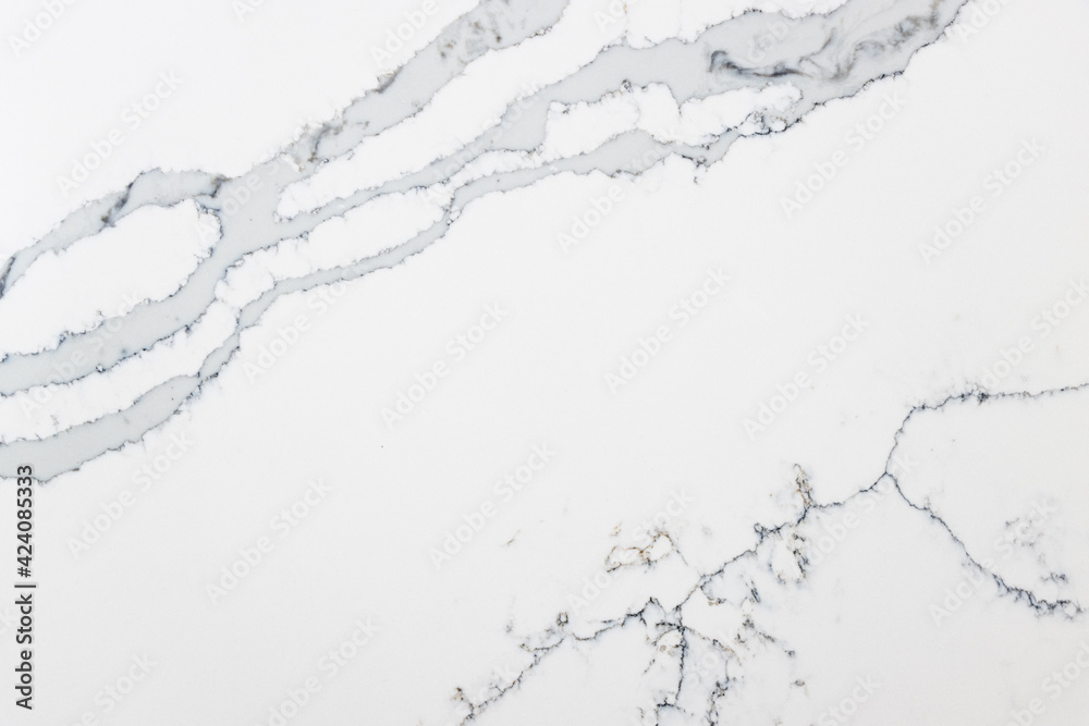 Close up of a quartz slab that contains both bold grey veins and subtle thin veins Close up of a quartz slab that contains both bold grey veins and subtle thin veins