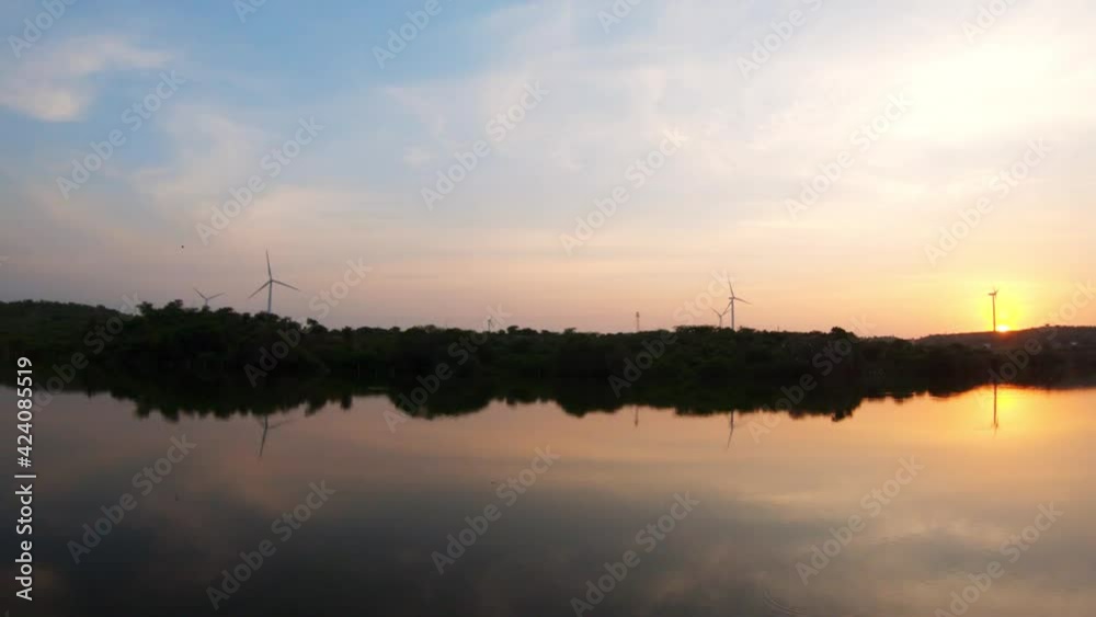 View of the sunset at the lake with windmills at Wankaner, Gujarat, India View of the sunset at the lake with windmills at Wankaner, Gujarat, India