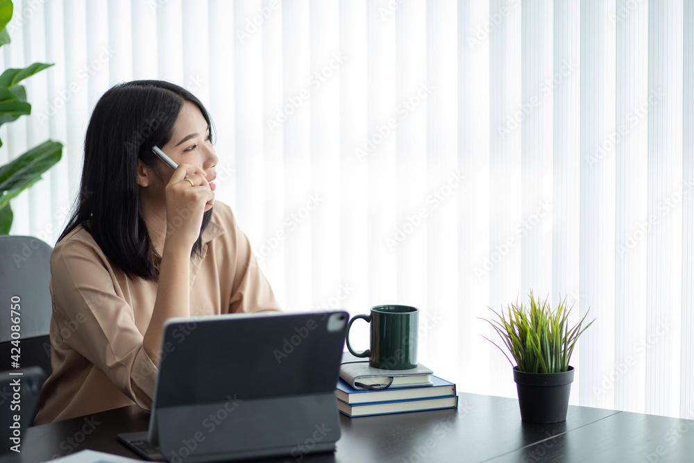 Portrait of Asian young female working on tablet at office Portrait of Asian young female working on tablet at office