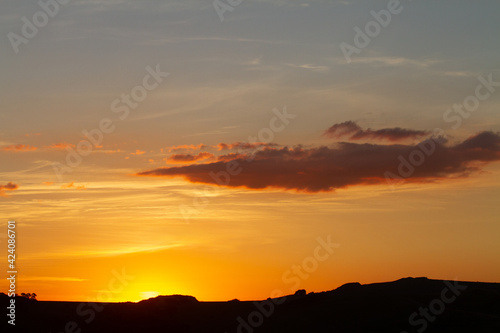 sunset with montain chain silhouette