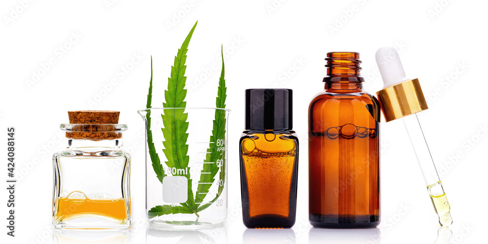 Glass bottles of cannabis oil and hemp leaves isolated on white background.. Glass bottles of cannabis oil and hemp leaves isolated on white background..