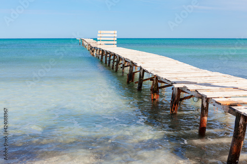 Old broken footbridge to the sea . Old pier with broken planks . Way to the sea 