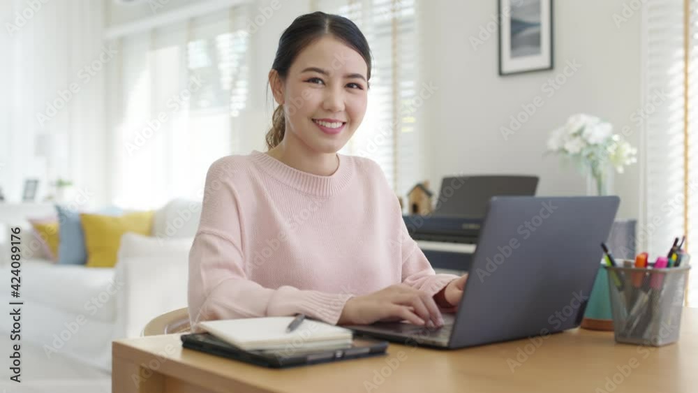 Portrait headshot young attractive beautiful asia female sit on desk smile to camera work at home remotely computer laptop job. College student, employee feeling cozy happy in holiday weekend leisure. Portrait headshot young attractive beautiful asia female sit on desk smile to camera work at home remotely computer laptop job. College student, employee feeling cozy happy in holiday weekend leisure.