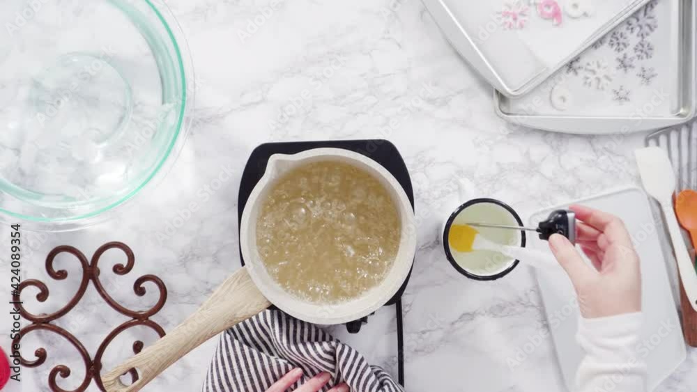 Flat lay. Step by step. Caramelizing sugar in a small cooking pot over the small electric stove. Flat lay. Step by step. Caramelizing sugar in a small cooking pot over the small electric stove.