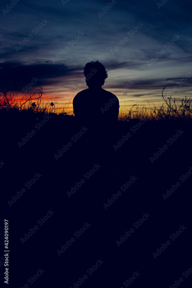 silhouette of  young  person in sunset