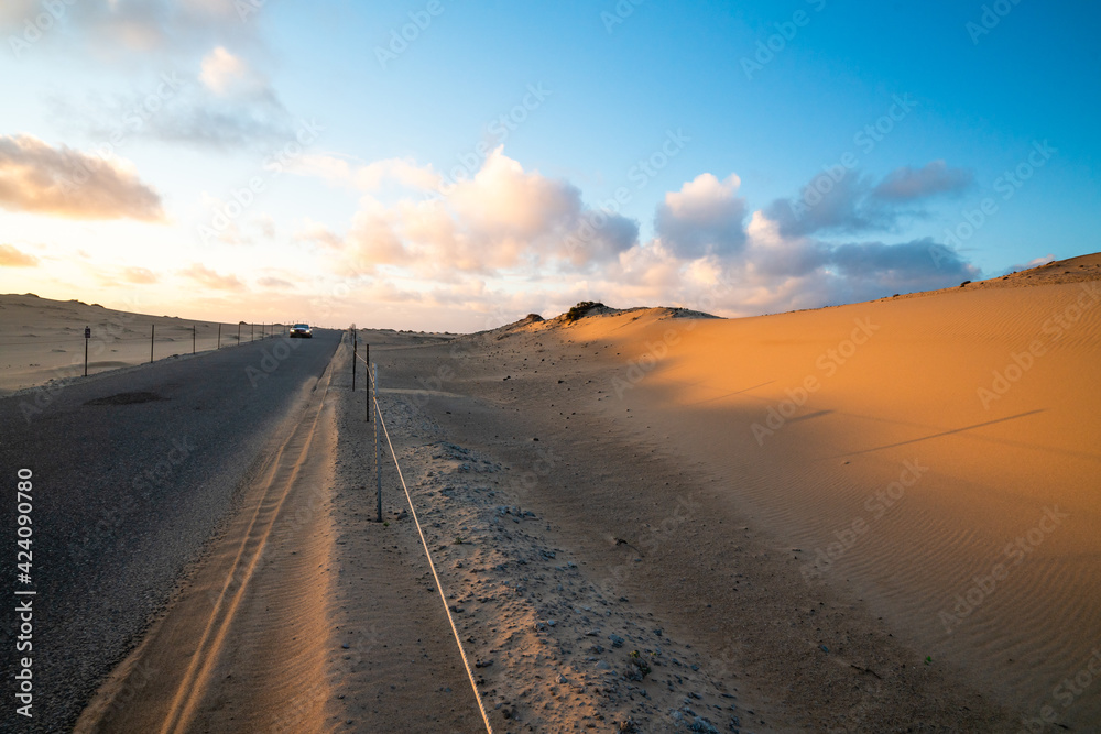 Road through sand dunes at sunset in Guadalupe-Nipomo Dunes National Wildlife reserve, California