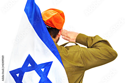 Israeli soldier with Israel flag salutes in an orange beret. White isolated background. Israel, IDF, soldier conscript or reservist photo