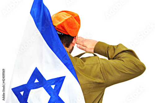 Obraz na plátně Israeli soldier with Israel flag salutes in an orange beret