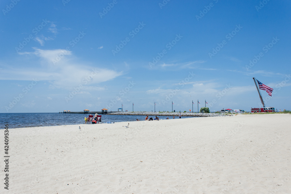 Seascape. People are resting on the ocean on a summer sunny day. Ken Combs Pier, Gulfport, Massachusetts, USA - 7-4-2019