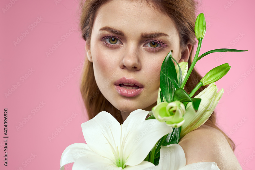 Beautiful woman with flowers on pink background makeup portrait model Beautiful woman with flowers on pink background makeup portrait model