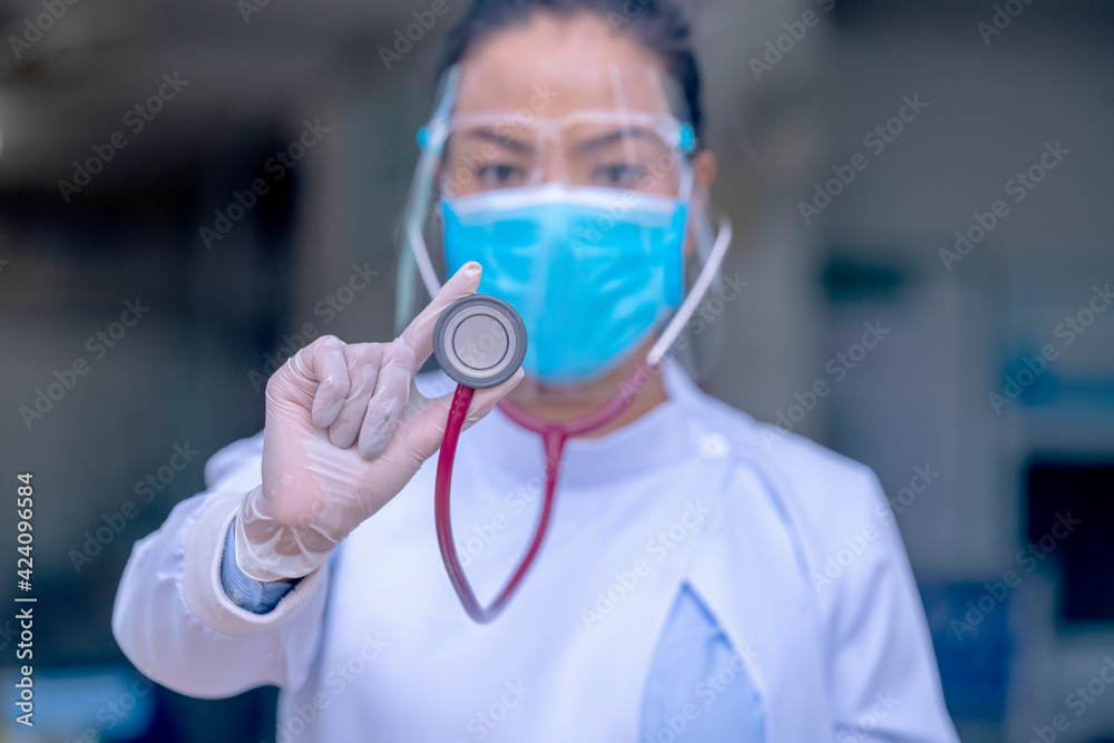 doctor wearing mask under face shield and stethoscope look at camera doctor wearing mask under face shield and stethoscope look at camera
