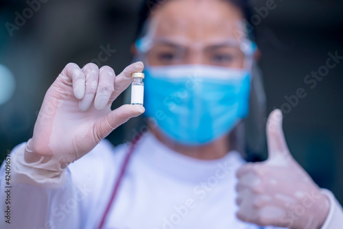 Fototapeta Naklejka Na Ścianę i Meble -  Close-up hand doctor or nurses showing proved Antiviral vaccine bottles.Doctor giving Prophylactic HPV vaccination