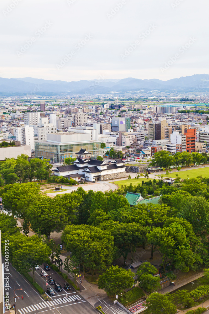 Toyama cityscape and Tetayama mountain range (Japan alps) views from Kasui park in Toyama city, Toyama, Japan.