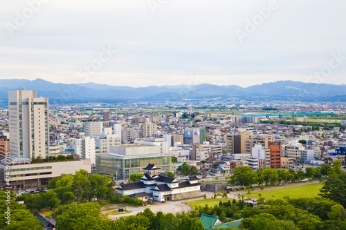 Toyama cityscape and Tetayama mountain range (Japan alps) views from Kasui park in Toyama city, Toyama, Japan.