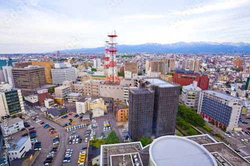 Toyama cityscape and Tetayama mountain range (Japan alps) views from Kasui park in Toyama city, Toyama, Japan. photo