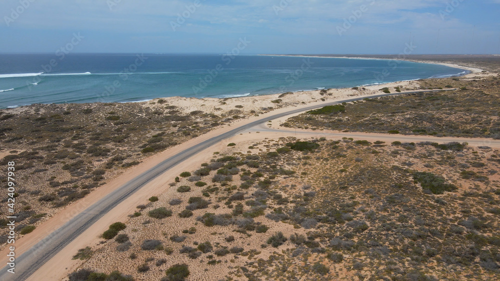 Aerial - road next to Pacific Ocean, Exmouth, Western Australia, circle shot