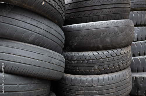 old used car tires stacked in piles