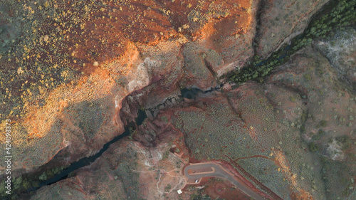 Aerial shot Over big Canyon In Karijini National Park with large Gorge and stream In Western Australia