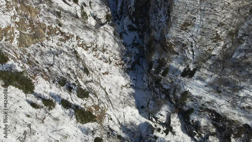 Deep Gorge in Winter. River Canyon Covered with Snow. Aerial Top View Deep Gorge in Winter. River Canyon Covered with Snow. Aerial Top View