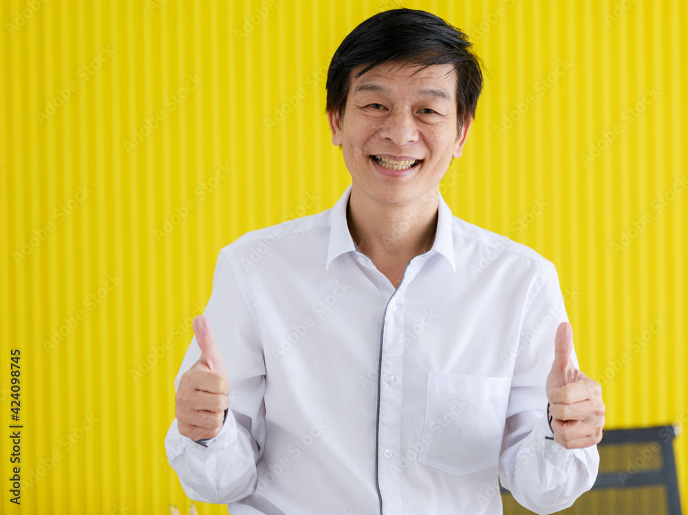 Portrait of senior middle aged businessman in white shirt standing and give two thumbs up with self-confidence in office. Portrait of senior middle aged businessman in white shirt standing and give two thumbs up with self-confidence in office.