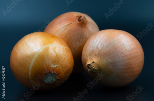 Three onions on a black background