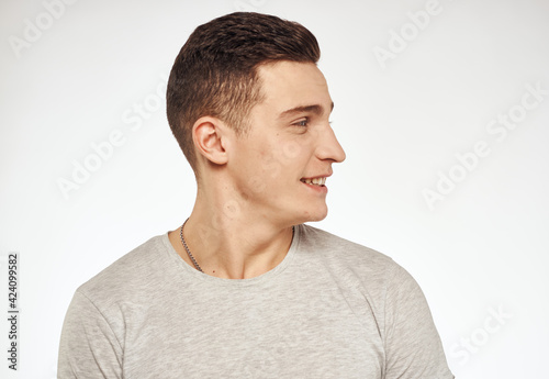 Handsome man in a T-shirt attractive look light background