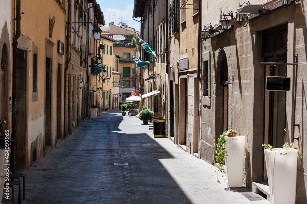 street in historical center of Arezzo with facade of medieval buildings. Tuscany, Italy
