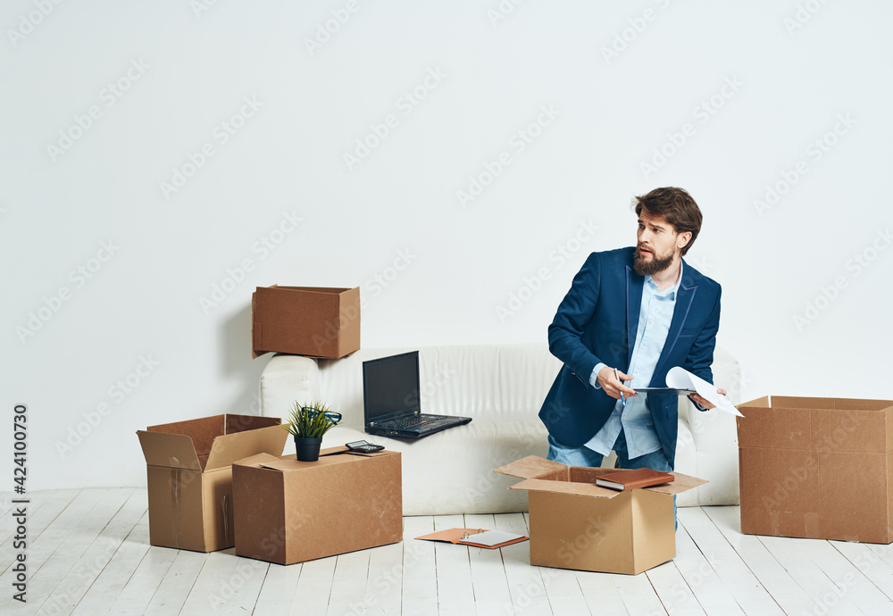 Business man unpacking boxes with things for an official Professional Business man unpacking boxes with things for an official Professional