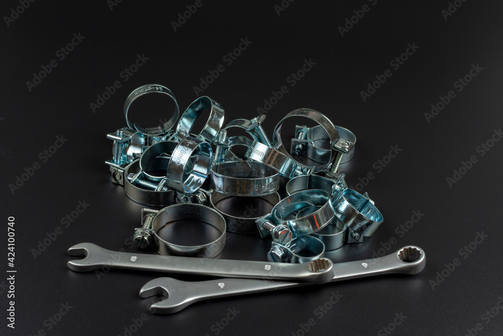 on a black background metal clamps and tools on a black background metal clamps and tools