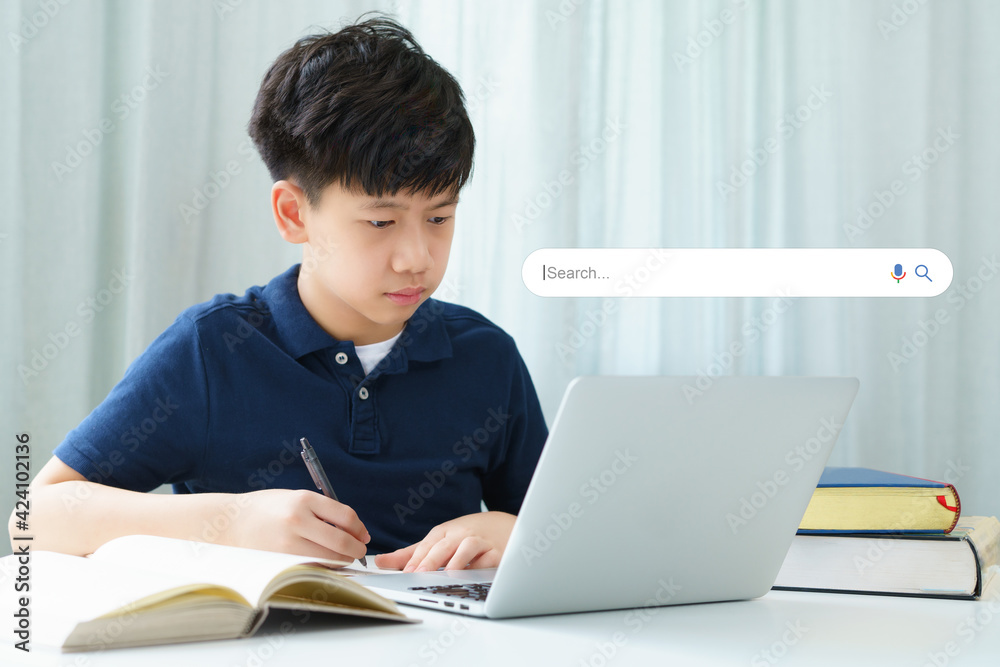 Search Engine Optimization - SEO concept. Portrait of an asian smart teenager boy using laptop computer a on the table. Machine learning, AI Artificial intelligence, Keyword, Online, Remote learning. Search Engine Optimization - SEO concept. Portrait of an asian smart teenager boy using laptop computer a on the table. Machine learning, AI Artificial intelligence, Keyword, Online, Remote learning.