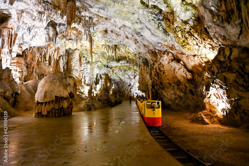 Underground tourist train in Postojna cave, Slovenia. It is the second-longest cave system in the country. photo