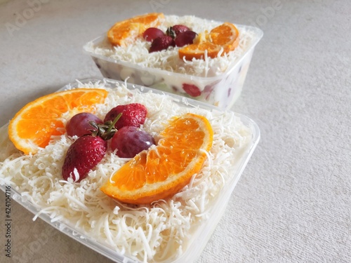 Fruit Salad With Cheese, Strawberry, Grape and Orange in Plastic Container. photo