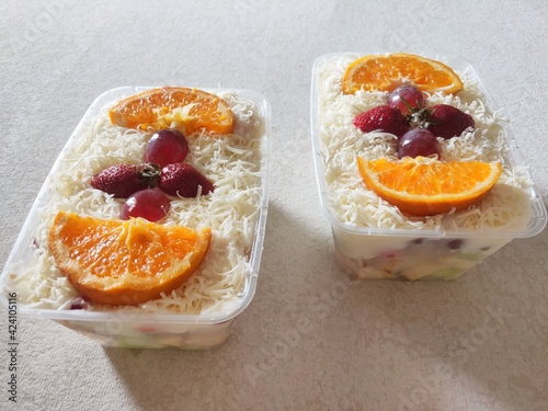 Fruit Salad With Cheese, Strawberry, Grape and Orange in Plastic Container. photo